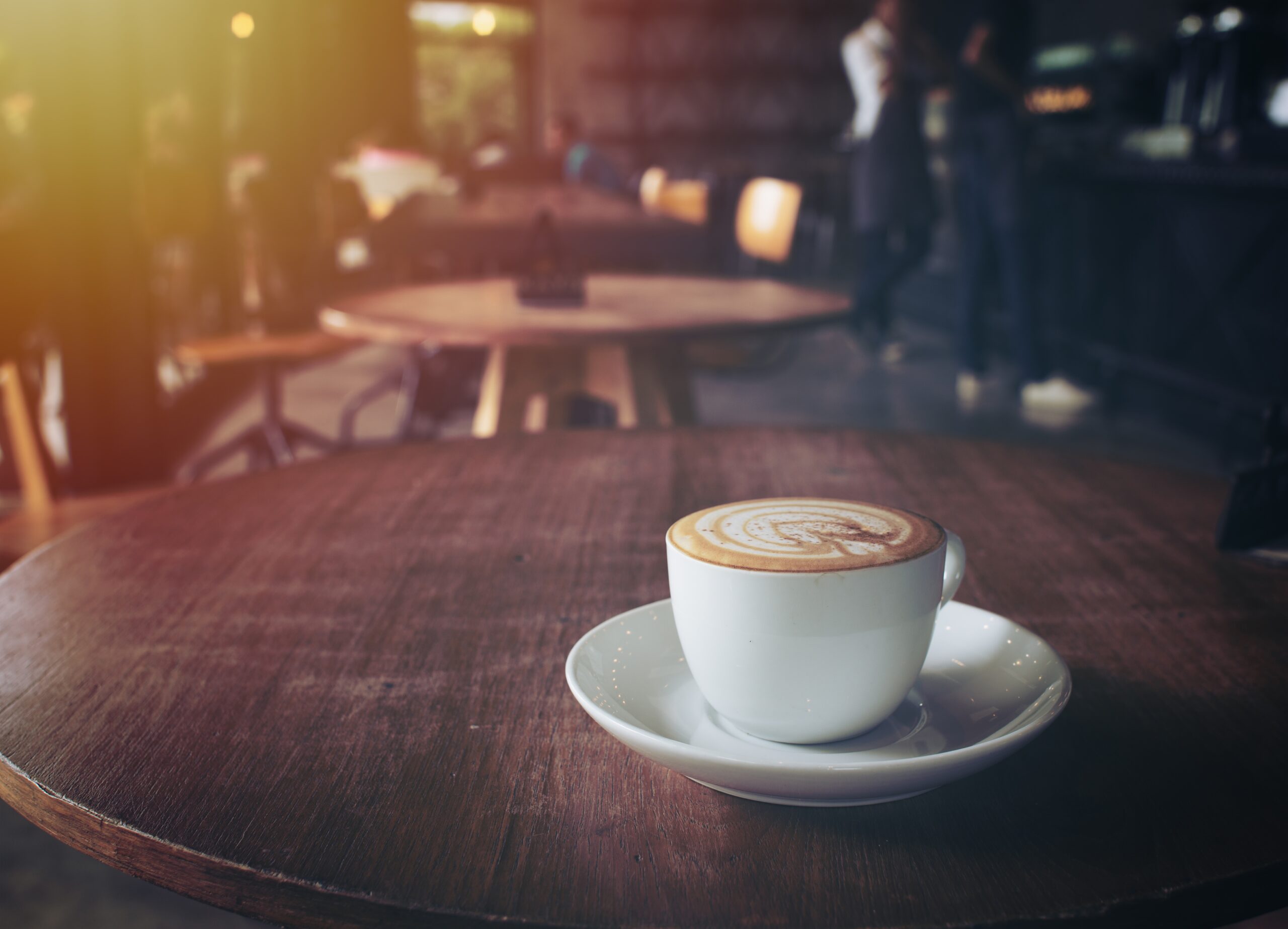 cup of coffee on table in cafe,vintage style.
